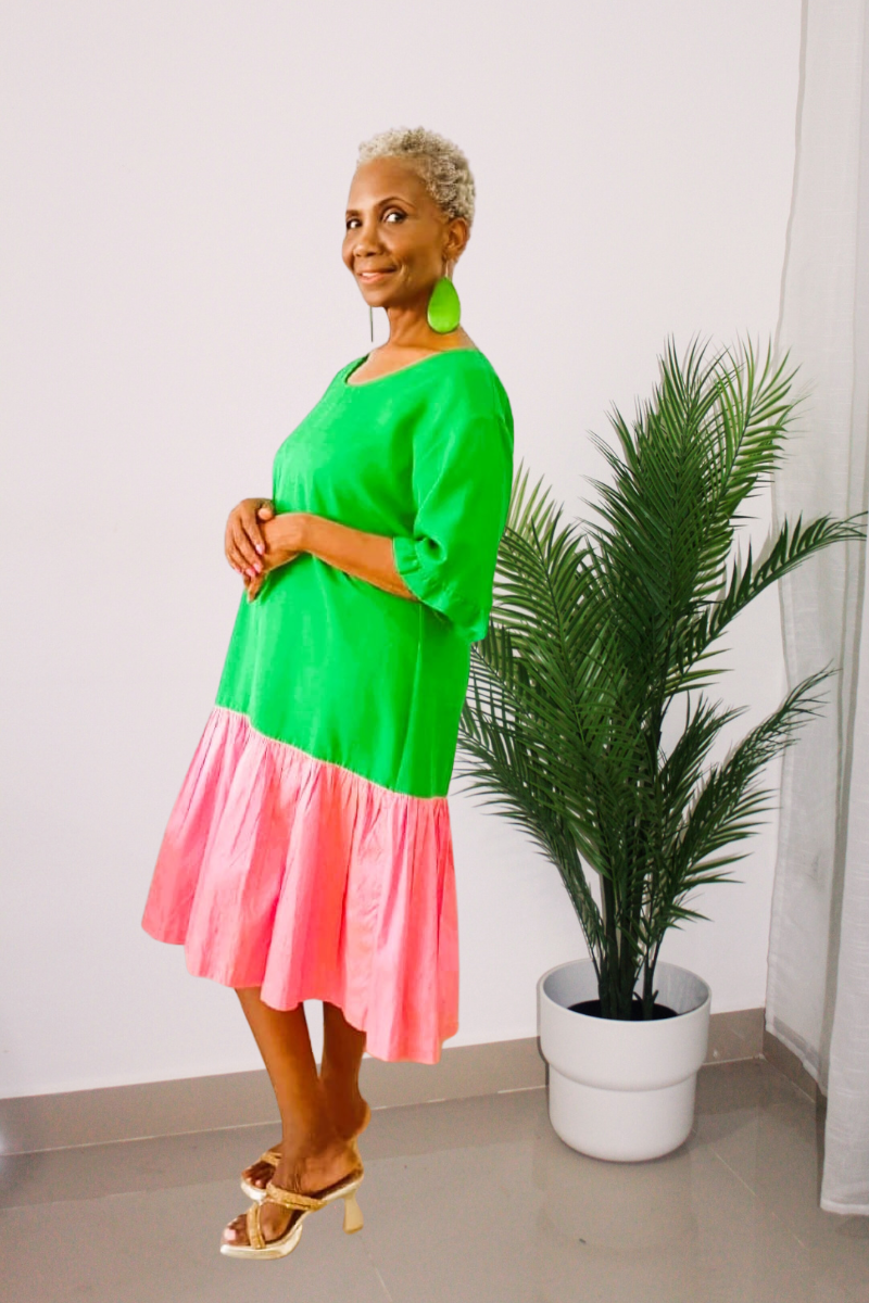 Woman wearing a green and pink dress in silk fabric